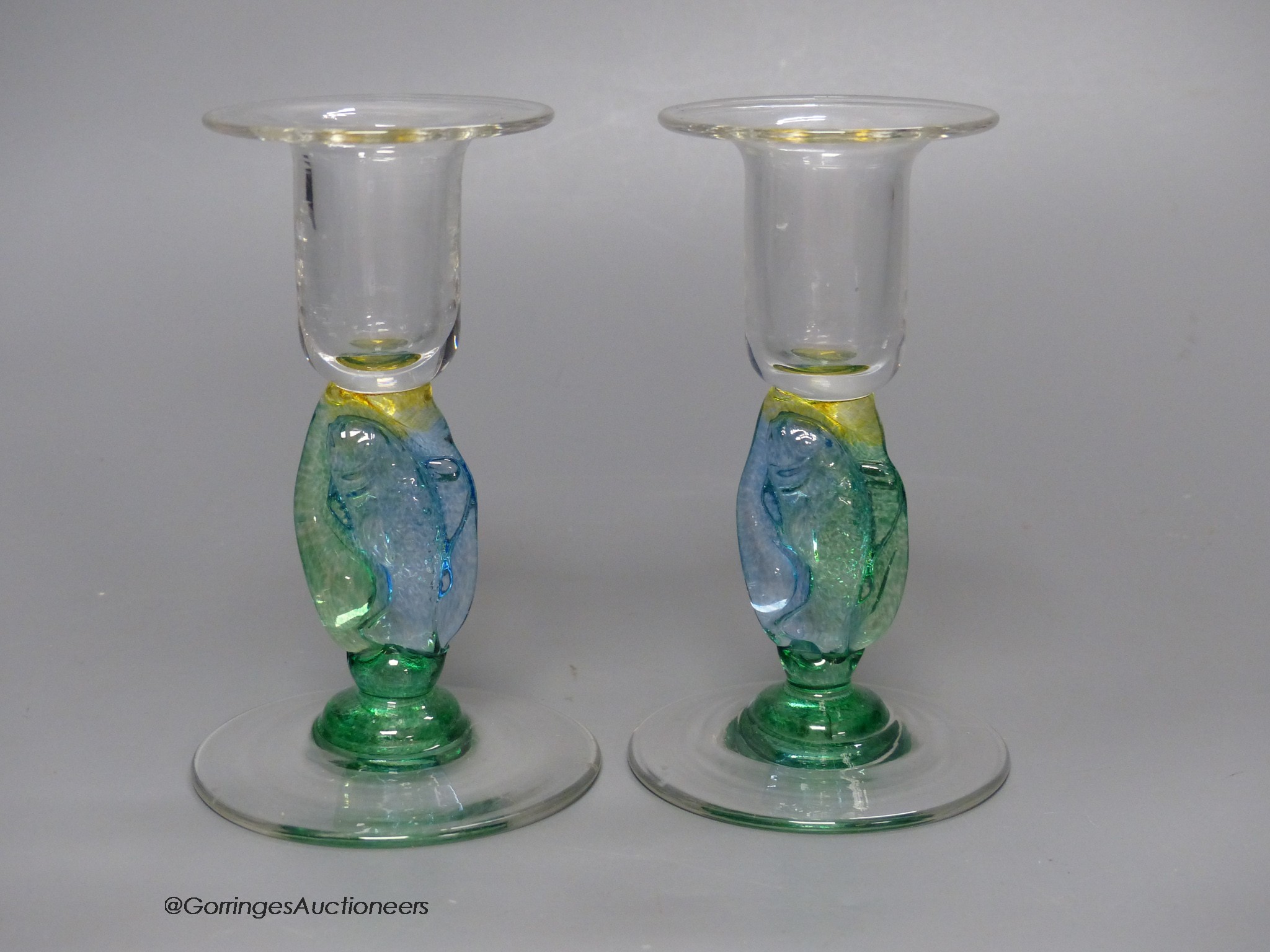 A pair of clear and coloured glass candlesticks by Helen Millard